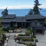 Aerial site view of a modern Sunshine Coast waterfront custom home integrated into coastal landscaping.